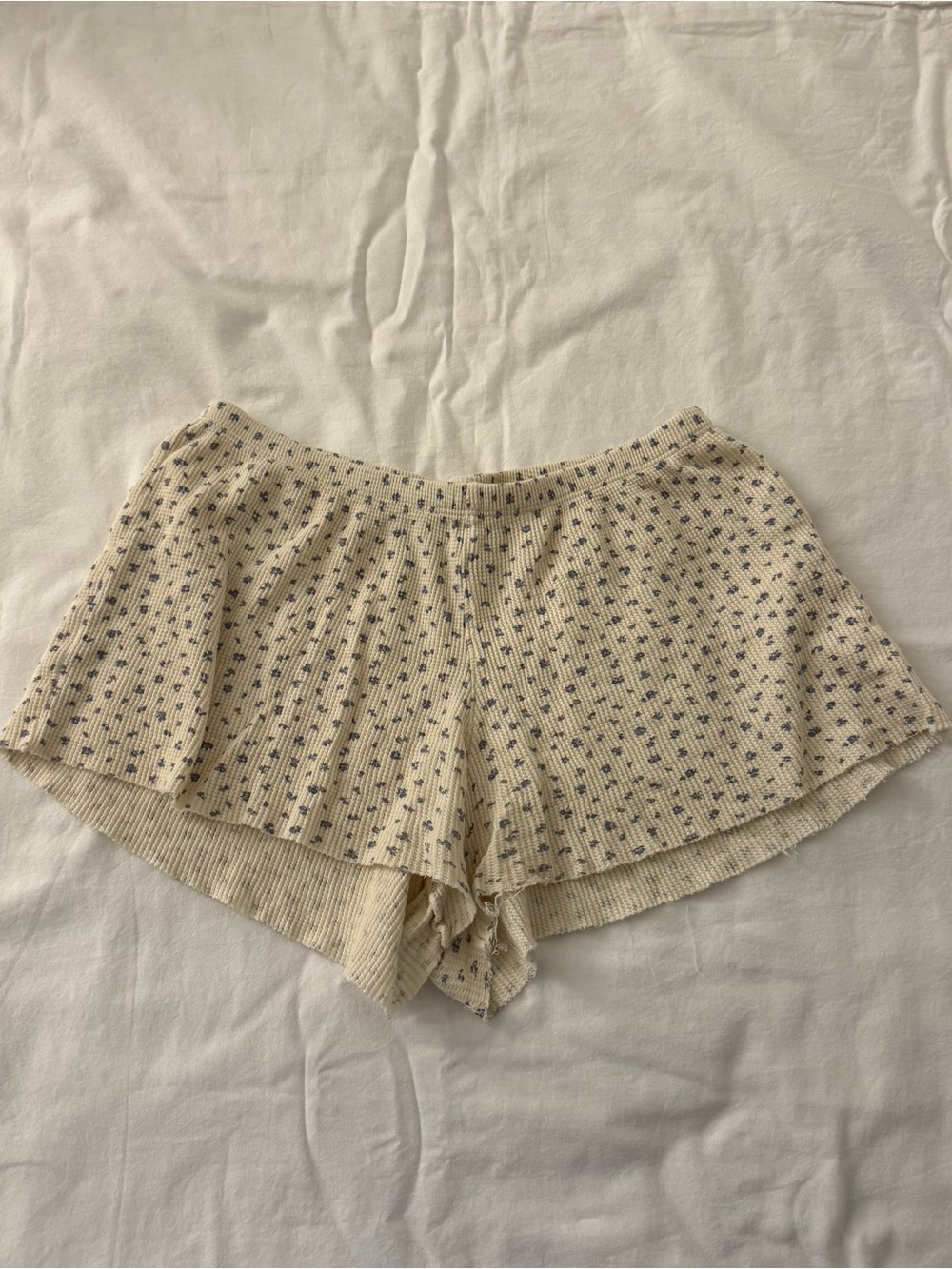 Brandy Melville butter yellow shorts with blue flower detailing all around